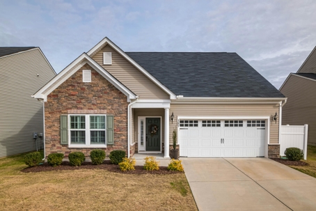 A modern suburban home with a dark asphalt shingle roof and neutral-toned siding, showcasing the impact of roofing color on curb appeal and home design.