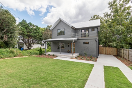 Modern gray home with a durable metal roof, highlighting low-maintenance roofing solutions.
