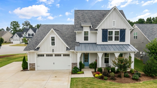 A modern suburban home with a newly installed asphalt shingle roof, illustrating the importance of post-storm inspections to detect potential damage.