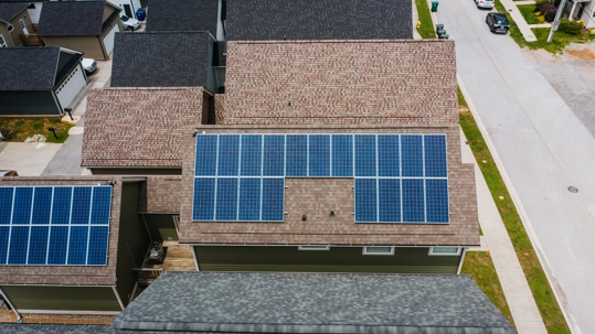 Sustainable roofing solution with solar panels on a residential property.
